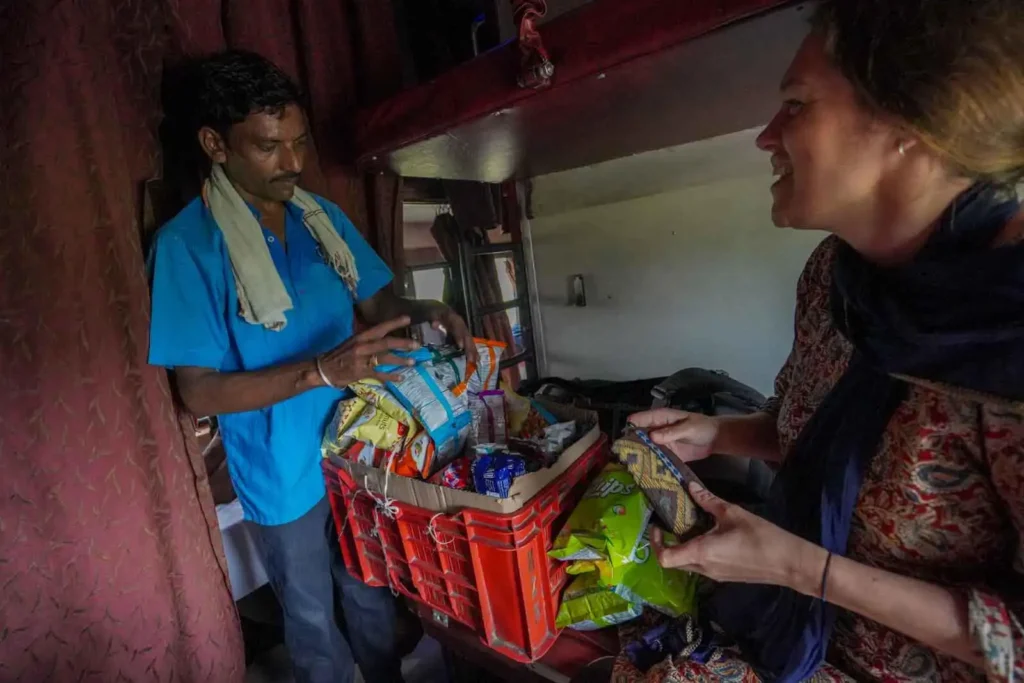 Buying snacks en route in AC 2-Tier (2A) on the train to Jaisalmer. 