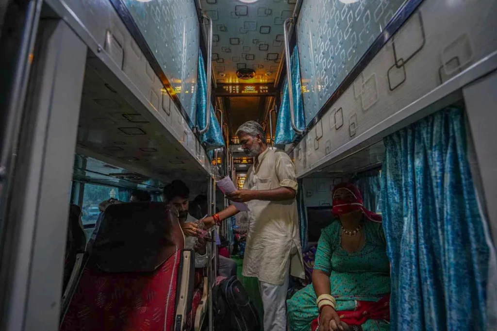 Attendant checking tickets on bus Jaisalmer to Jodhpur. 