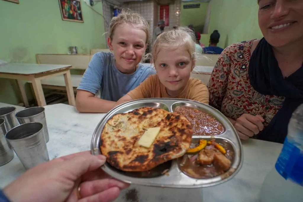Amritsari Kulcha served with a dollop of butter and chickpeas at Bhai Kulwant Singh Kulchian Wale. Famous Food in Amritsar. 
