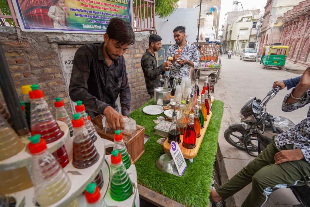 Friendly vendors shaving the fresh ice near the Junagarh Fort entrance in Rajasthan. 