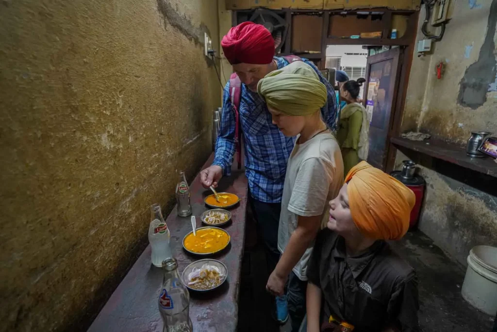 Fresh onions, Dal and paneer curries to go with the hot fresh Laccha Paratha at Kali Da Dhaba.