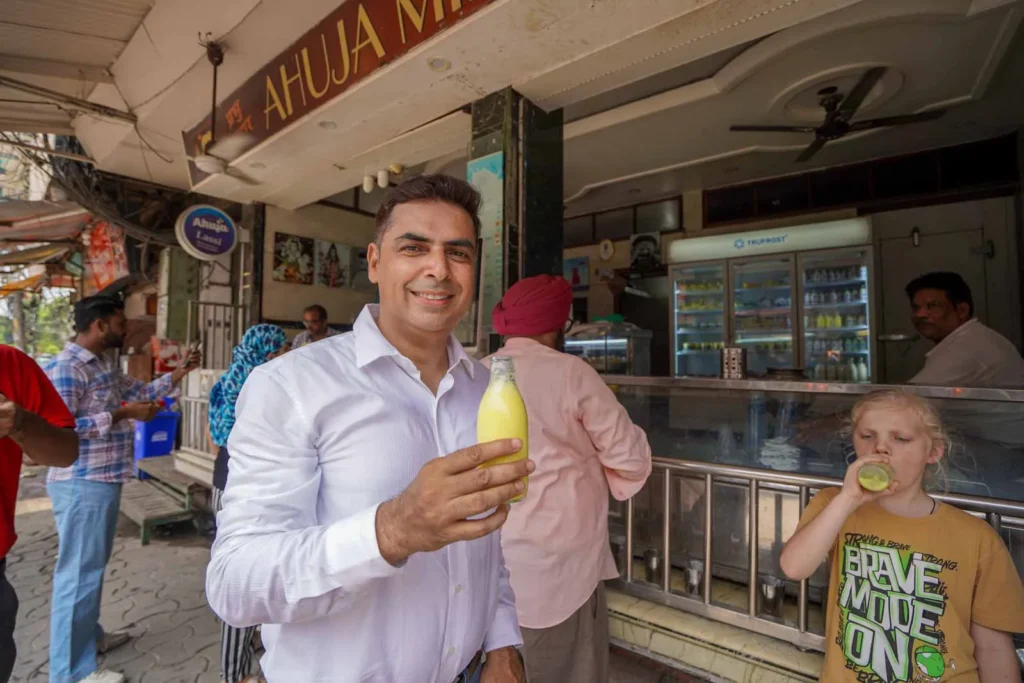 Anil and Oscar trying Kesar Badam at the famous Ahuja Milk Bar on our Food Tour in Amritsar. 