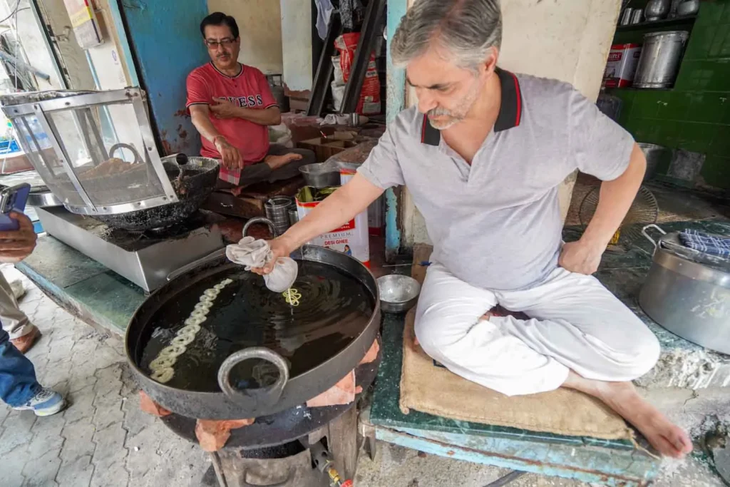 Piping the Jalebi into the hot oil in swirls at the famous Gurdas Ram Jalebi Wala.