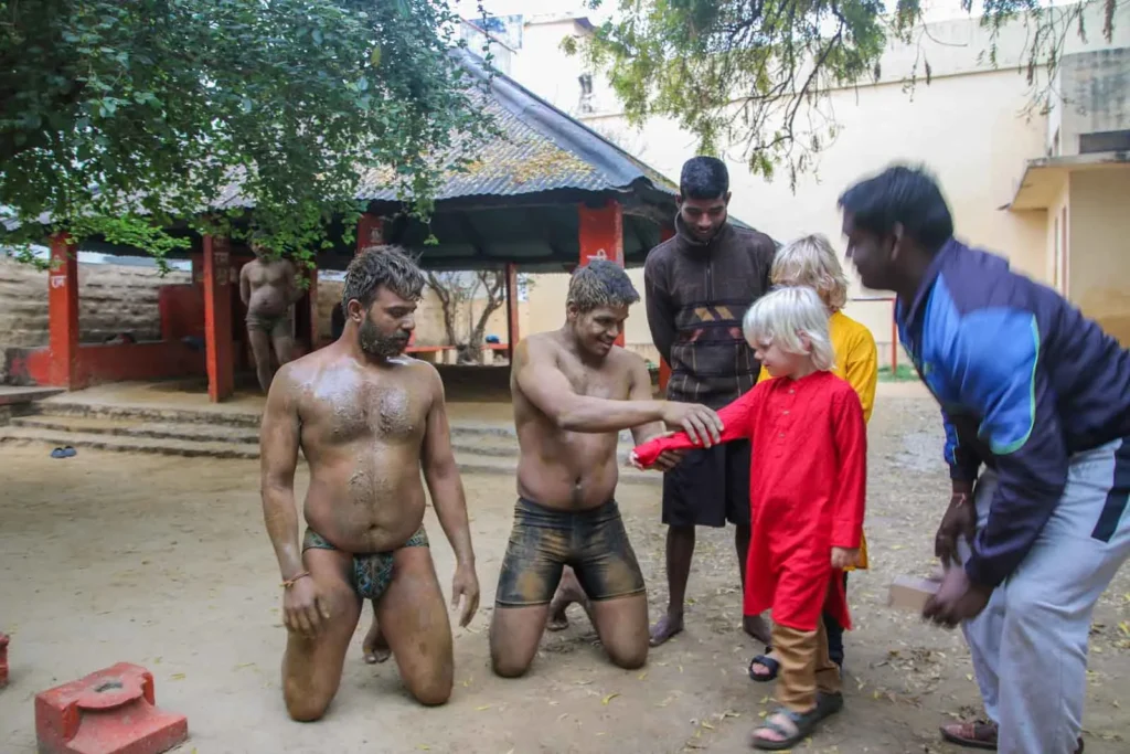 Meeting the wrestlers in Varanasi with kids and our guide, Ravi. 