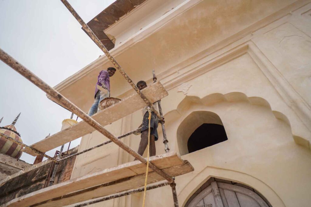 Painters up scaffolding in Delhi. 