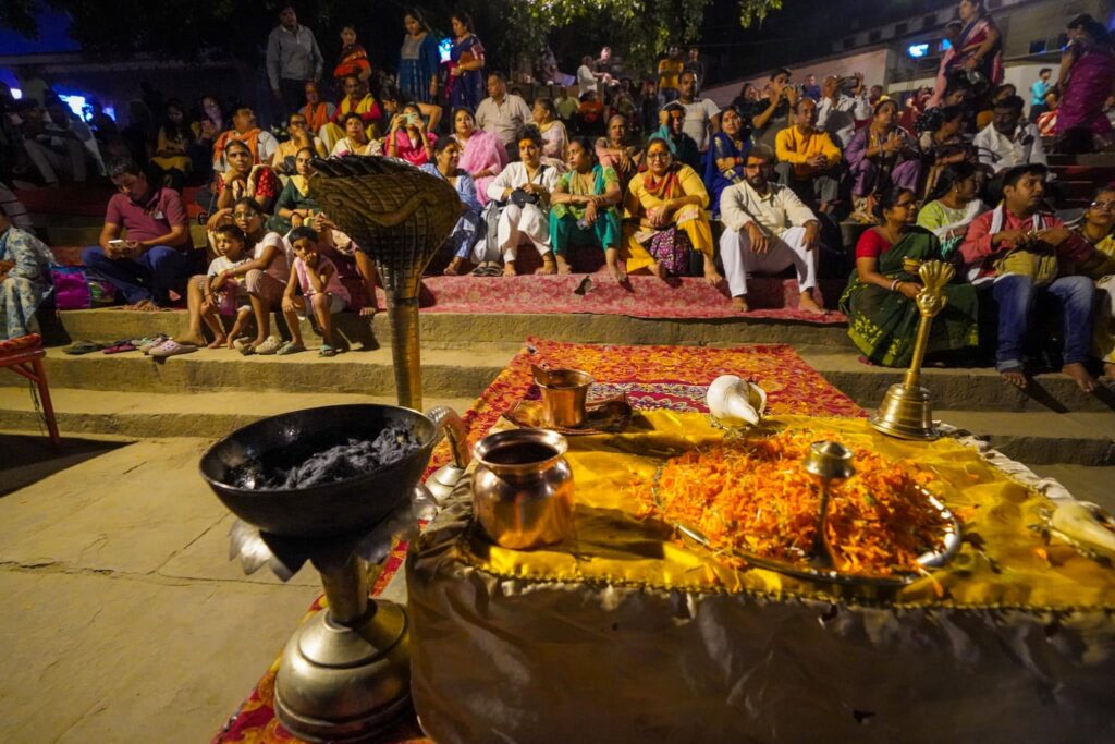 Alters and temples being set up along the shore line with candles and marigolds and pots for smoke and flames for the Ganga Aarti. 