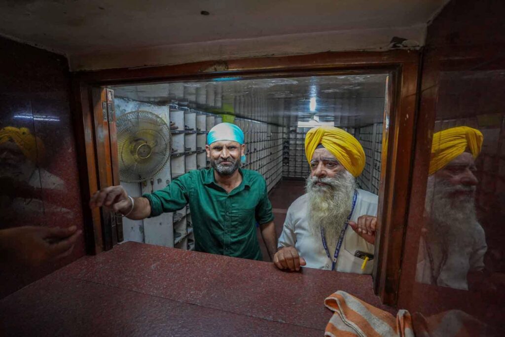 The men volunteering to collect shoes for visitors to enter the Golden Temple.