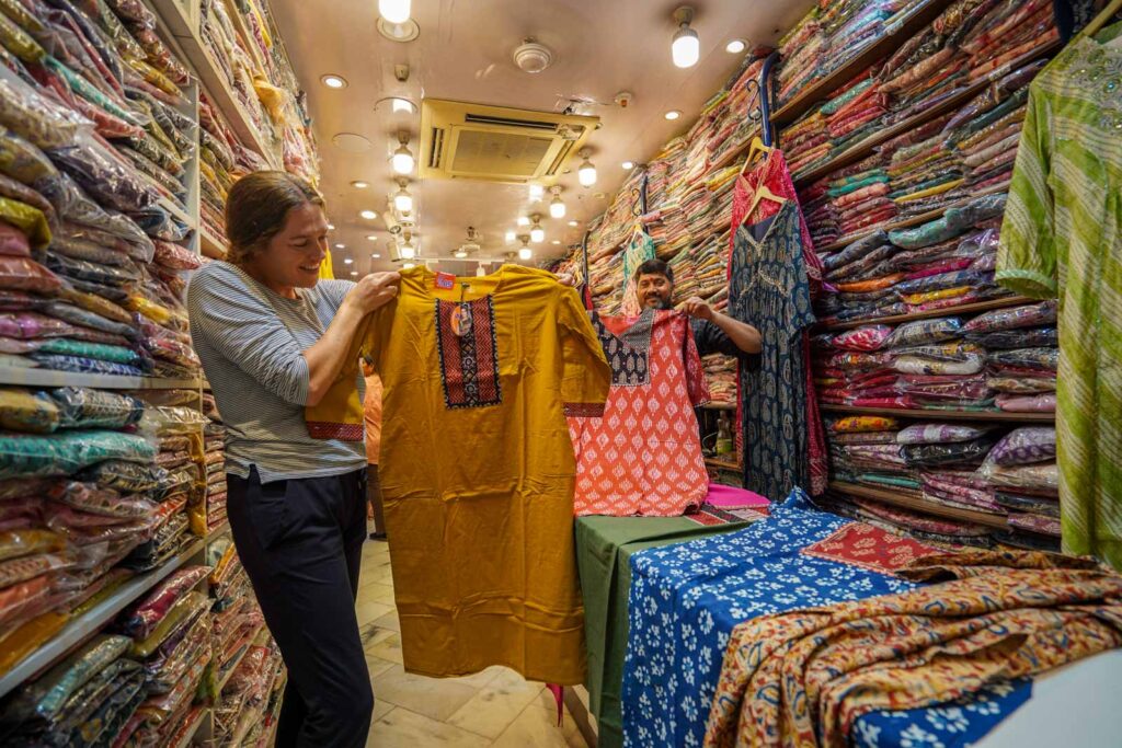 Colourful Kurt shopping for clothes to wear in India at Sarojini Market in Delhi. 
