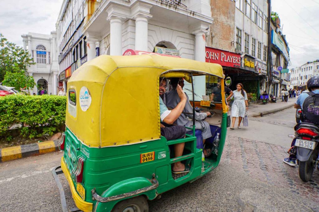 A friendly rickshaw whizzing past in Connaught Place. 